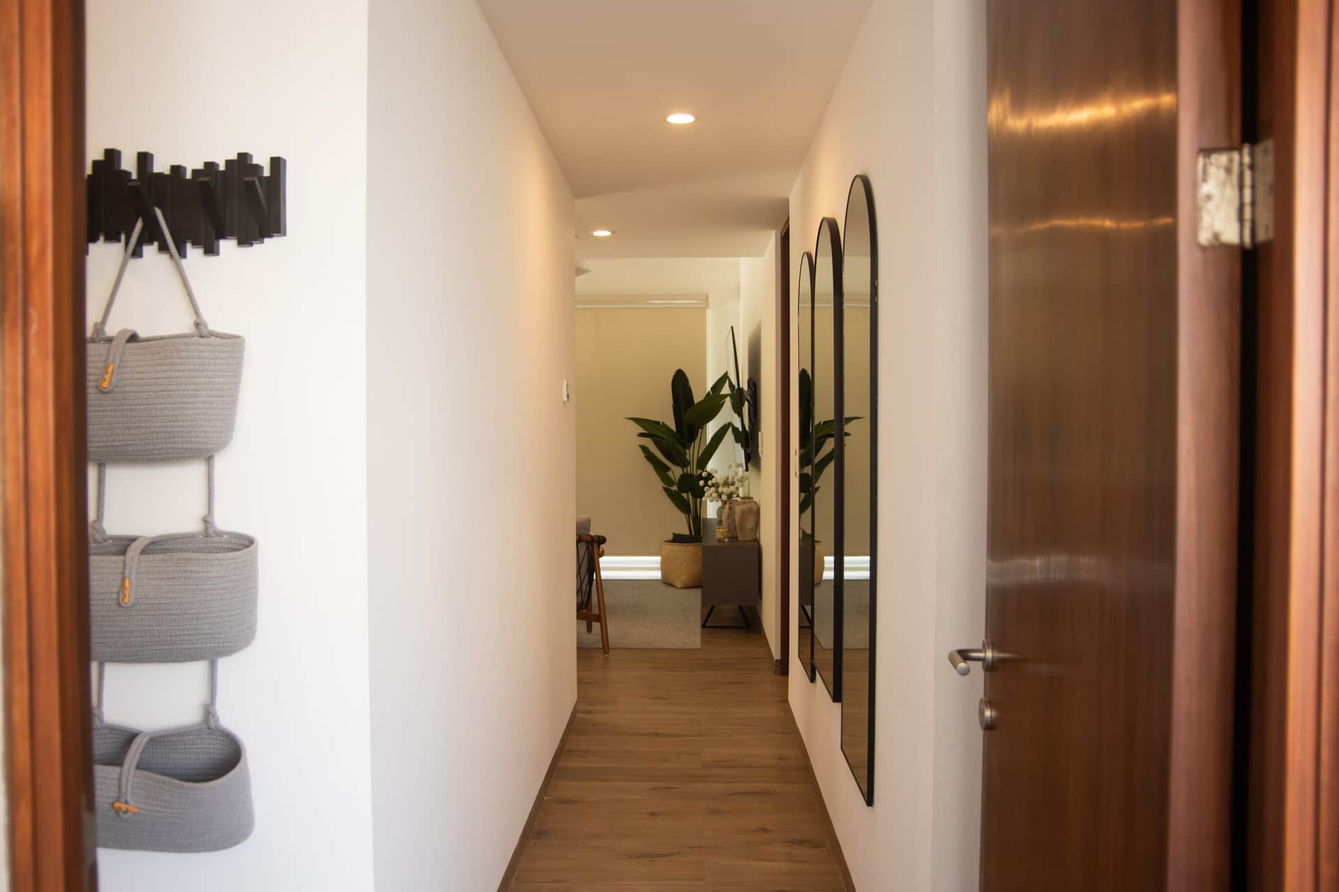 Modern hallway with arched mirrors at The Leaf Playacar