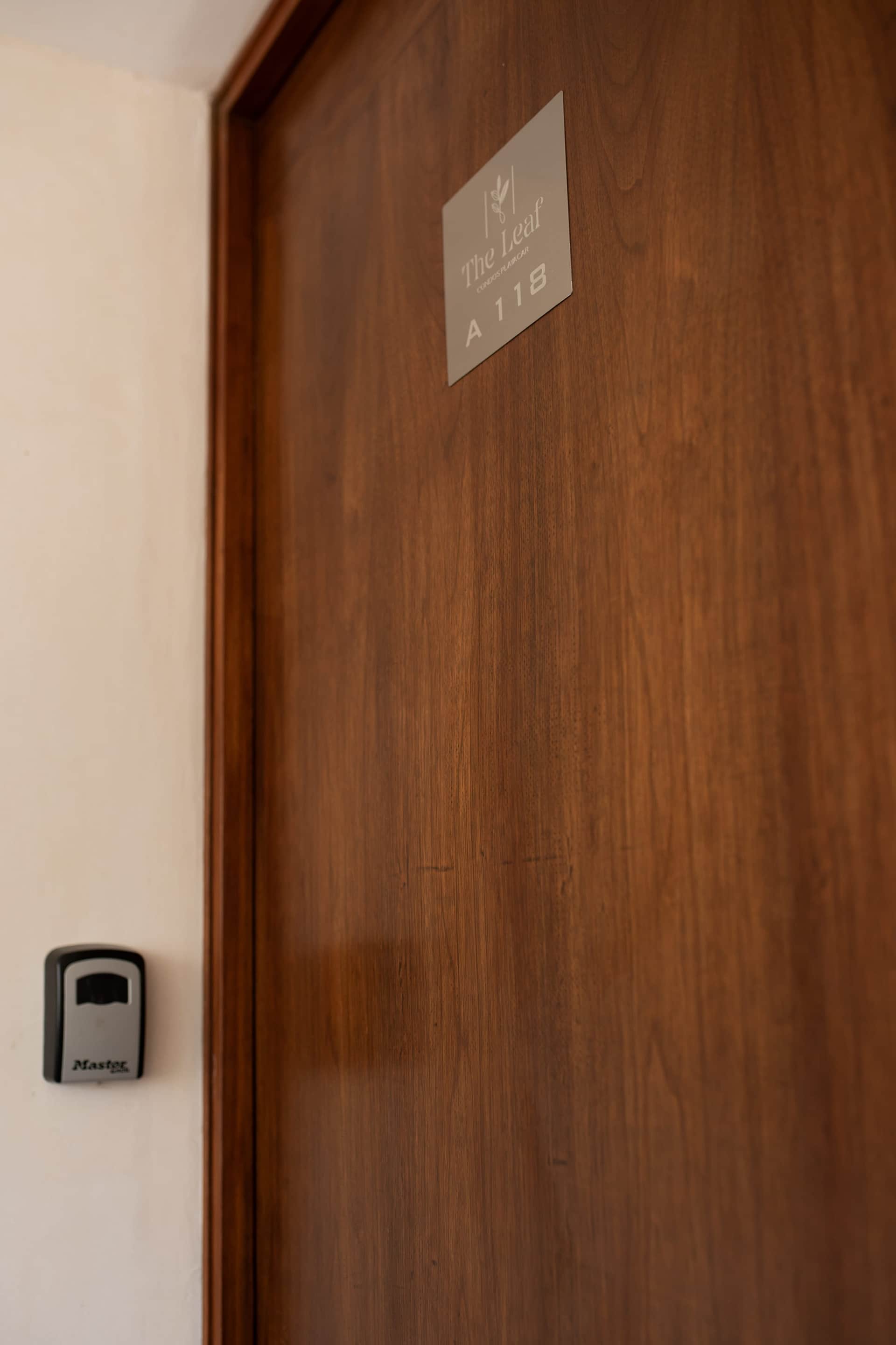 Unit A118 entrance door with key lockbox at The Leaf Condos Playacar