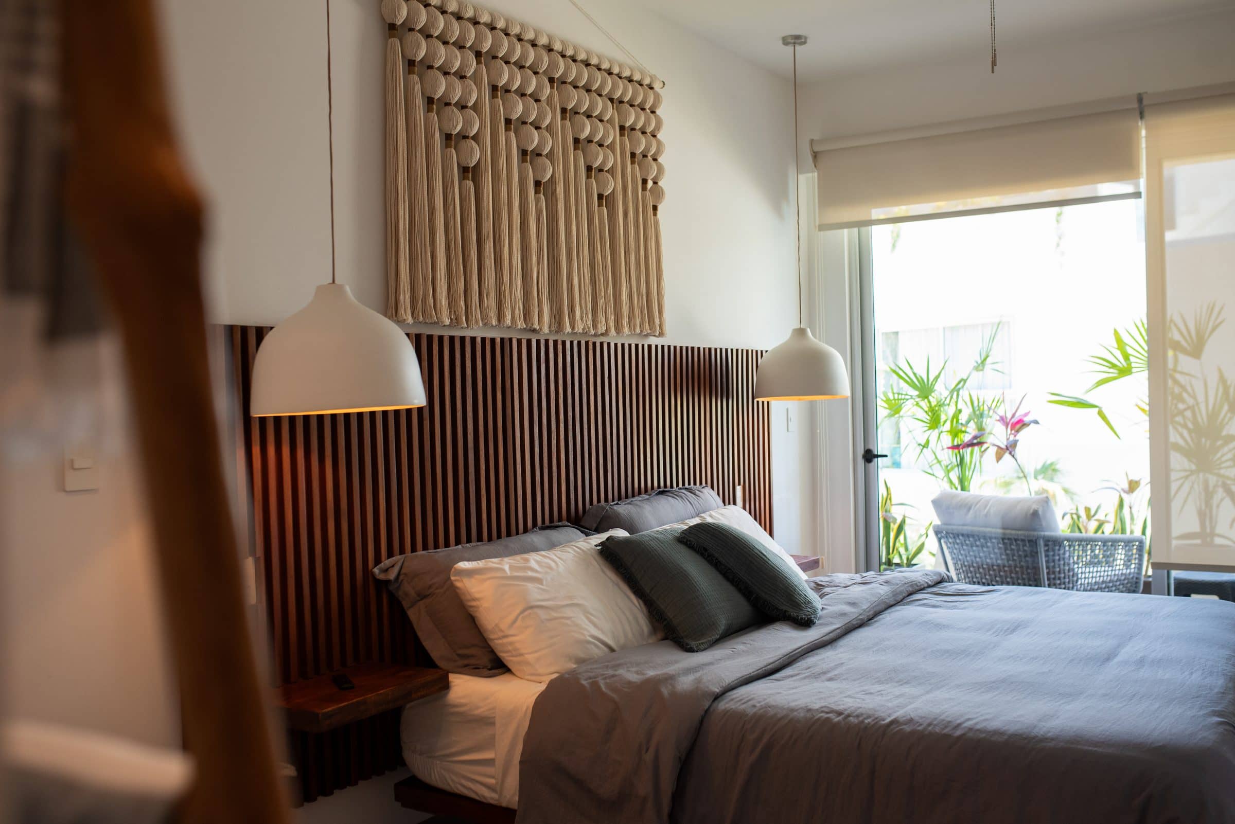 Bohemian bedroom with macrame headboard at The Leaf Playacar