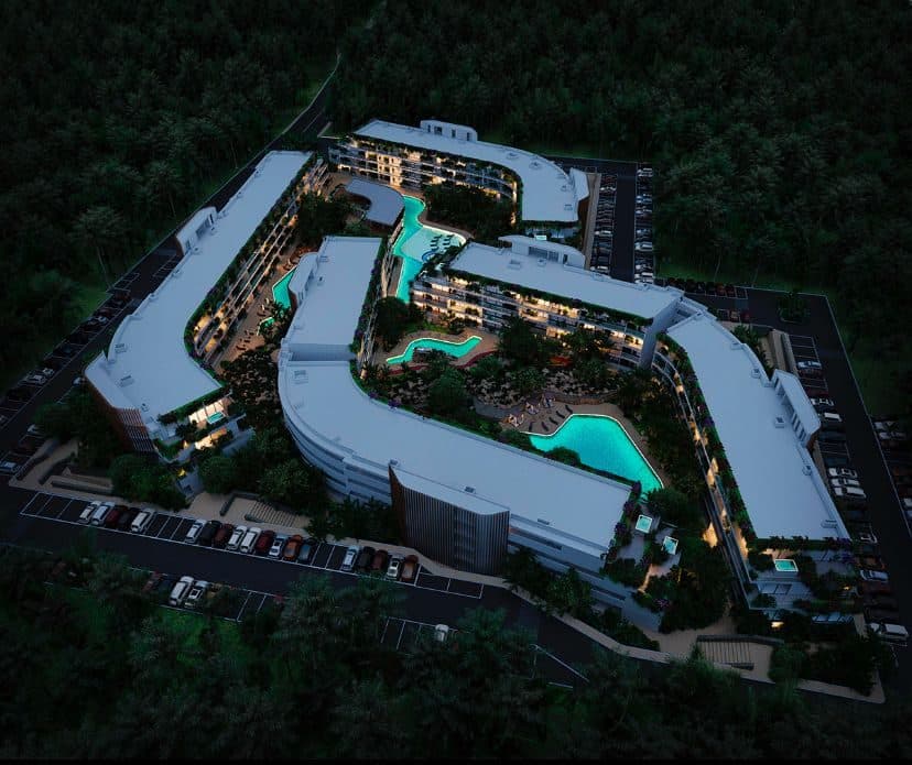 Aerial night view of four illuminated resort pools at The Leaf Playacar