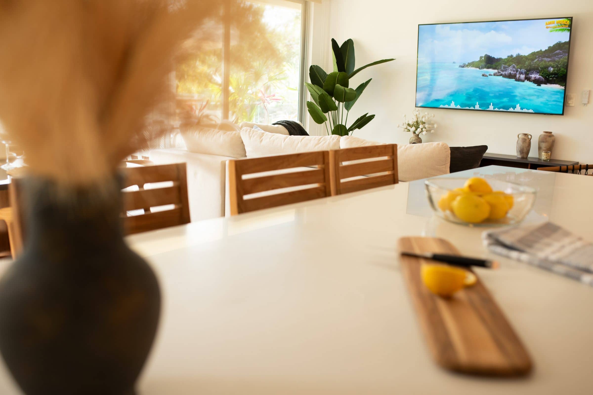 Bright living room and kitchen island at The Leaf Playacar